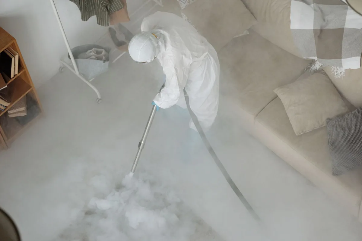 Biohazard cleanup technician in protective equipment, Waynesville, MO